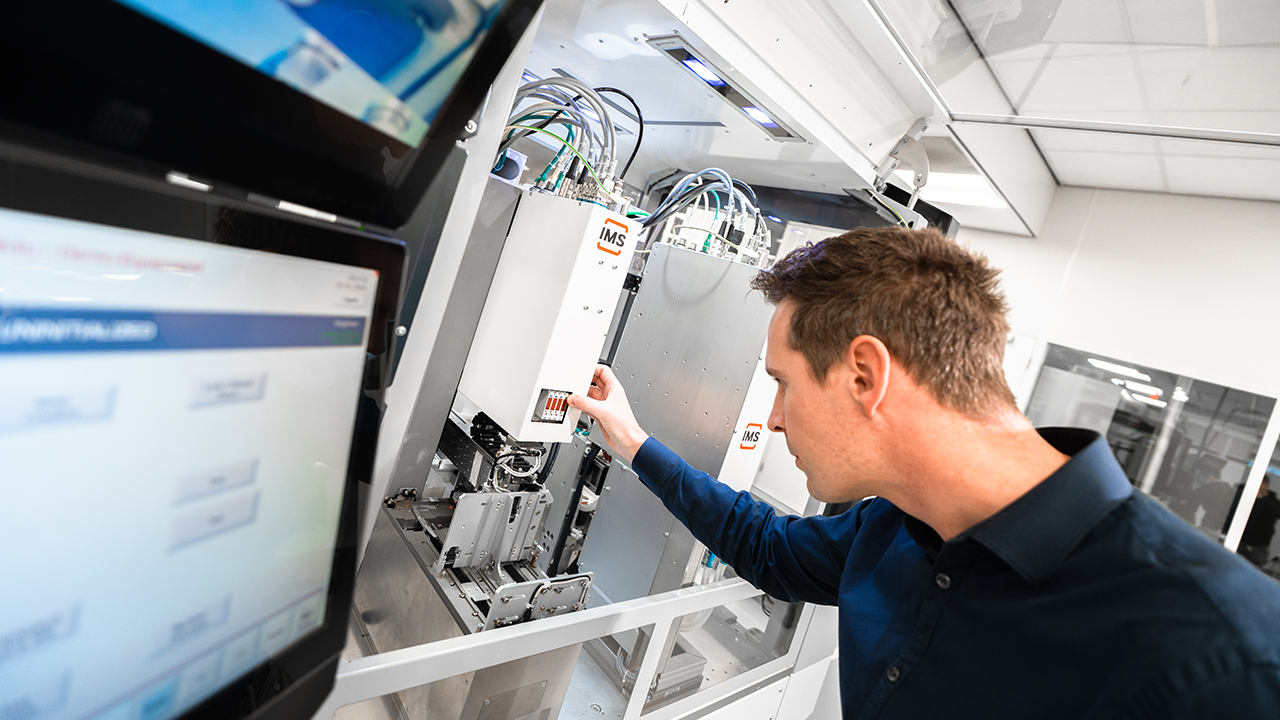 Engineer adjusting IMS machine